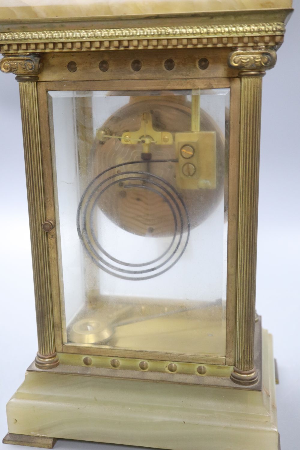 A four glass onyx and brass clock, height 31cm